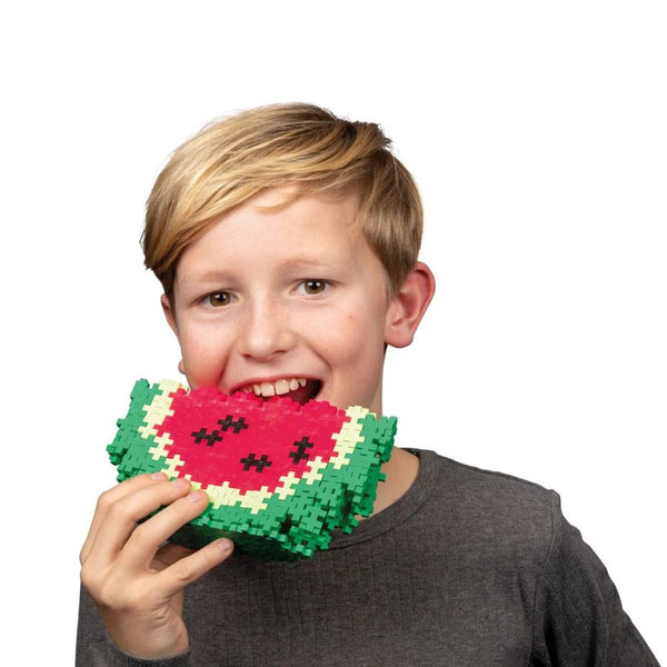 Plus-Plus 240 building blocks tube showing Danish-made interlocking pieces of boy holding a watermelon
